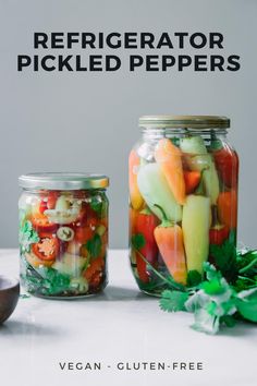 two mason jars filled with pickled peppers and carrots