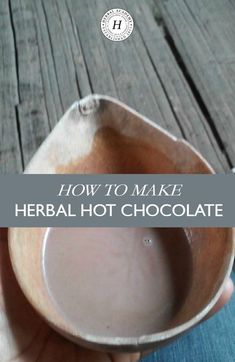 a person holding a bowl with the words how to make herb hot chocolate on it