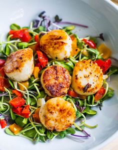 scallops and vegetables in a white bowl