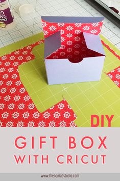 an open box sitting on top of a cutting mat with the words diy gift box with cricut