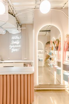 the inside of a store with lights on and an open counter in front of it