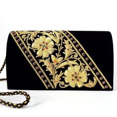 Luxury black velvet evening clutch bag, expertly hand embroidered by master zardozi artisans. Bright gold tone metallic flowers are embellished with genuine semi precious stones, including garnets and carnelian, to add an eye-catching pop of color, texture and sparkly bling to your overall party look. It is just the right size to hold your essentials for the night - phone, credit cards, money, keys and lipstick. The shoulder strap keeps your hands free for carrying a drink or holding a plate of Metallic Flowers, Gold Clutch Bag, Embellished Purses, Formal Clutch, Evening Fashion, Embroidered Handbag, Velvet Clutch, Floral Clutches, Gold Clutch