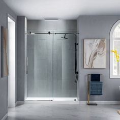 a bathroom with a glass shower door and marble flooring is shown in front of an arched window