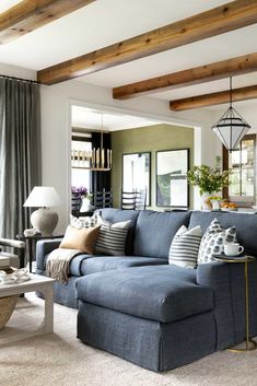 a living room filled with lots of furniture and decor on top of carpeted flooring