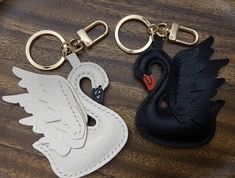 two black and white swan shaped leather key chains