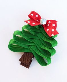 a green christmas tree with red bows and white polka dots on it's head