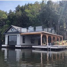 a boat dock with a house on the water