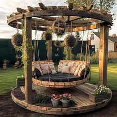 a wooden swing bed in the middle of a yard with hanging plants and potted plants