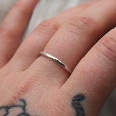 This adjustable hammered sterling silver ring is designed for both men and women who enjoy wearing minimalist style jewelry. This ring is super lightweight and comfortable, making it the perfect everyday wear with any outfit. Stack it or mix and match with other metals. Puffy fingers are no match for this ring! Completely handcrafted by me (Kahlia) in Washington State out of my school bus work studio. Handmade with raw 925 sterling silver wire, this ring is hammered to perfection and polished to Simple Hammered Ring Jewelry, Everyday Adjustable Hammered Stackable Rings, Minimalist Hammered Stackable Rings, Minimalist Adjustable Hammered Midi Rings, Dainty Hand Forged Rings For Everyday, Minimalist Hammered Ring With Open Band, Minimalist Hammered Open Band Ring, Everyday Hammered Open Ring, Minimalist Hand Forged Sterling Silver Rings