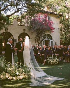 a bride and groom standing in front of an outdoor ceremony