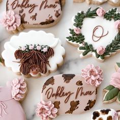 decorated cookies are arranged on a marble surface