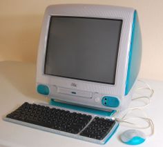 a desktop computer sitting on top of a white desk next to a keyboard and mouse