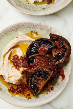 a white plate topped with food and sauce