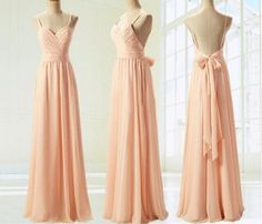 three dresses on mannequins, one in peach and the other in orange