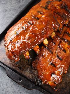 ribs covered in bbq sauce on a grill