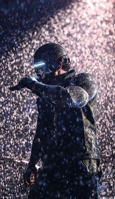 a man standing in the rain with his hands on his face and an umbrella over his head