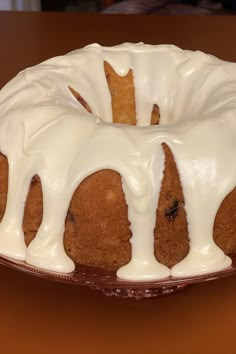 a bundt cake with white icing on a plate