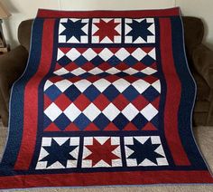 a red white and blue quilt on a couch