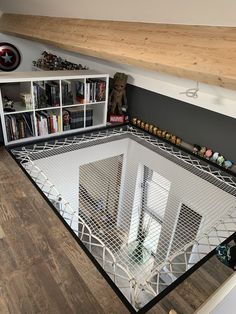 a living room with a book shelf and bookshelf on top of the floor