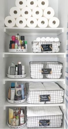 the shelves are organized with toilet paper, baskets and other items to keep them organized