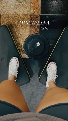 a person standing next to a weight scale