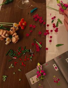 the table is covered with plastic flowers and beads