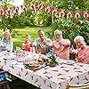 a group of people sitting around a table outside