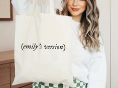 a woman holding a shopping bag with the word shana written in pink on it