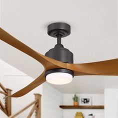 a modern ceiling fan with wooden blades in a home living room or dining room area