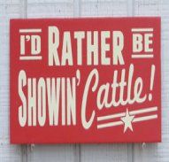 a red and white sign on the side of a building that says, david rather brown's pigs