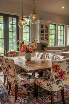 the dining room table is surrounded by floral upholstered chairs and an area rug