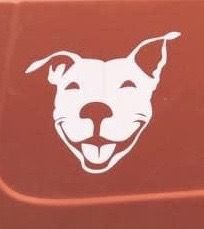 a dog sticker on the side of a computer keyboard