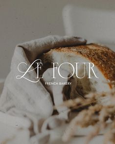 the french bakery logo is displayed on top of a piece of bread