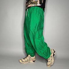 "Vintage Track Pants Kelly Green Nylon Joggers Elastic Cuffs has Ankle Zippers 90s Skate / Streetwear Great Condition: 9/10 Men's Size: 2X-Large My Hands in Pockets = It has Pockets No Hands in Pockets = Does Not Have Pockets Drawstring Will be Visible in Forward Pic, if not Visible it Does Not Have a Drawstring About me: I am 6' 0\" for reference I generally wear a Large (32\" inseam) I Model XS to 2XL sweatpants, I find that you can often size up or down with 95% of sweatpants and they fit the same" Green Parachute Pants With Elastic Waistband For Sports, 90s Baggy Parachute Pants For Spring, Green Parachute Pants For Streetwear, Green 90s Style Streetwear Bottoms, Stretch Parachute Pants For Hip Hop Streetwear, Retro Green Bottoms For Streetwear, Green Retro Bottoms For Streetwear, Green Nylon Parachute Pants For Streetwear, Summer Streetwear Nylon Parachute Pants