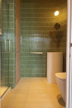 Kit Kat shaded green curved wall detail bathroom walls with bronze mirror and towel rail, freestanding white circular basin and wall mounted bronze tap Curved Shower Wall, Public Restroom Design, Bar Tile, Shower Mosaic, Mosaic Bathroom Tile, Green Tile Bathroom, Curved Wall