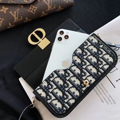 an iphone case with a pattern on it and a phone in the other handbag