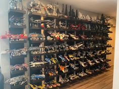 a room filled with lots of toy cars and toys on shelves next to each other