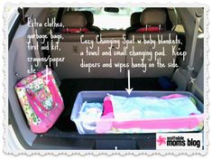 an open trunk in the back of a car filled with baby clothes and diapers