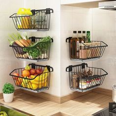 three metal baskets filled with fruits and vegetables on top of a kitchen counter next to a sink