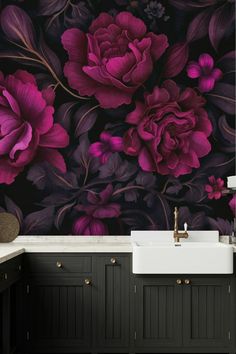 a bathroom with black and purple flowers on the wall next to a white sink under a faucet