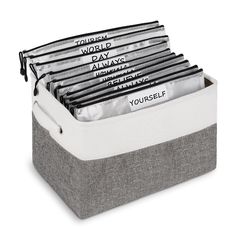 a gray and white storage box filled with lots of papers on top of each other