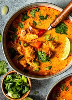 two bowls filled with soup and garnished with cilantro