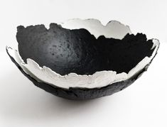 a black and white bowl sitting on top of a table