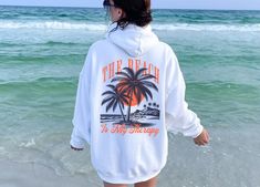 You will love this beach hoodie! It's the perfect trendy hoodie to wear to the beach and makes a great gift for beach lovers! PRODUCTION TIME: 1-3 business days  SHIPPING TIME: 2-5 business days PRODUCT DESCRIPTION: Our unisex heavy blend hooded sweatshirt is relaxation itself. Made with a thick blend of cotton and polyester, it feels plush, soft and warm, a perfect choice for any cold day. In the front, the spacious kangaroo pocket adds daily practicality while the hood's drawstring is the same Travel Hoodie, Beach Sweatshirt, Hoodie Cozy, Beach Lovers, Cozy Sweatshirts, Cold Day, Pocket Pouch, Color Matching, Hooded Sweatshirts