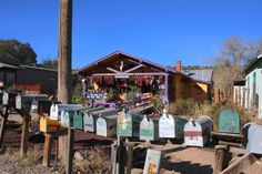 many mailboxes are lined up in front of a small building with a cross on it