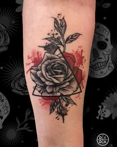 a black and red rose tattoo on the leg