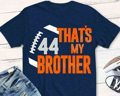 a t - shirt that says, that's my brother with an orange football on it