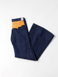 "This is a pair of Antonio Guiseppe designed jeans. The 1970s artist crafted jeans feature dark wash denim with a tooled leather patch across the back yoke. The jeans have a high waist, flared leg, and hidden stash pocket.  * Antonio Guiseppe * dark wash denim * leather artwork across back yoke * bell bottoms CONDITION In good condition with wear consistent with age and use. Missing the woven Guiseppe label on back.  MEASURED SIZE: 29 x 33 MEASUREMENTS Waist:  29\"  ...  73.7 cm Inseam:  33\"  . Retro Fitted Patchwork Jeans, Retro Patchwork Fitted Jeans, Vintage Recycled Denim Jeans For Fall, Retro Dark Wash Rigid Denim Flare Jeans, Retro Flare Jeans In Dark Wash Rigid Denim, Designed Jeans, Leather Artwork, Victorian Shoes, 70s Denim