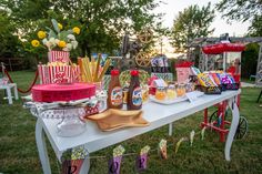 an outdoor picnic with food and drinks on the table