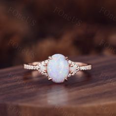 Vintage Oval white Opal Engagement Ring moissanite side stone in rose gold. Moissanite Bridal Wedding Ring,Art Deco,Unique Setting, Wedding Band In solid 14k or 18k rose/white/yellow gold,Promise ring,Christmas Gift,Anniversary gift for her. Details --Engagement Ring-- Stone: Moissanite Weight: 1.5 Carat Stone Size: 6x8mm Shape: Oval cut Side stones: Opal + Moissanite ◇◇Processing time◇◇ Any item on my store is handmade,made to order,no stock. Typically,it takes 3-4 weeks to complete the item. ◇◇Delivery time◇◇ --Domestic-- Standard shipping:5-7 working days for arrival Express shipping:2-4 business days for arrival --Overseas-- Standard shipping:1-2/3-4 weeks for arrival Express shipping:3-5 business days for arrival ❤I'll do my best to meet these shipping estimates, but cannot guarantee Oval Three Stone Opal Promise Ring, White Rings With Side Stones As Gift, White Wedding Rings With Side Stones, White Jewelry With Side Stones As A Gift, White Jewelry With Side Stones For Gift, Boho Vintage Engagement Ring, Gold Three Stone Engagement Ring, Oval Opal Ring, White Opal Engagement Ring